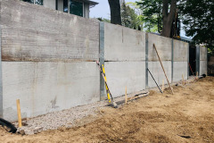 Soldier pile and precast concrete panel retaining wall under construction. Mississauga, Ontario.
