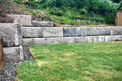 4’ high precast concrete block, retaining wall with a slope on top. Hamilton, Ontario.