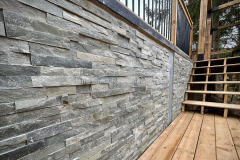 Natural stone veneer finish on a soldier pile and precast concrete panel retaining wall. Burlington, Ontario.