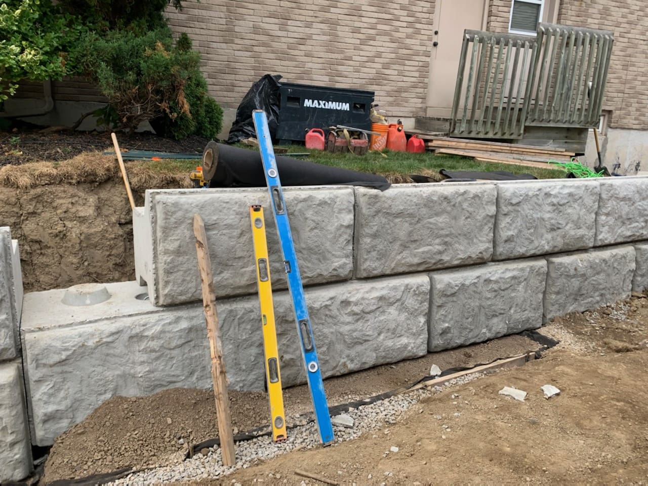 Stone retaining wall with levels and tools