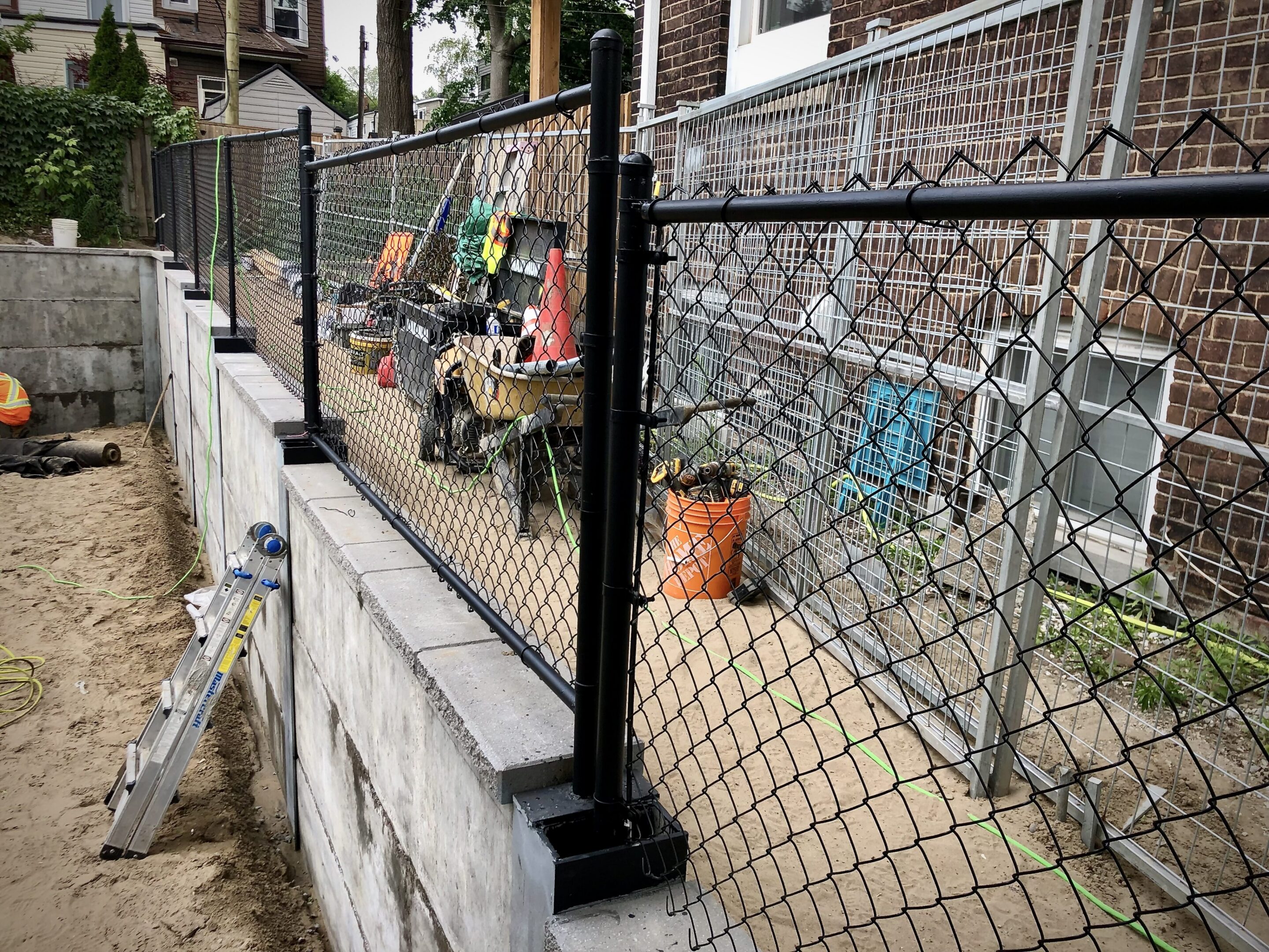 Chain-link fence along concrete retaining wall