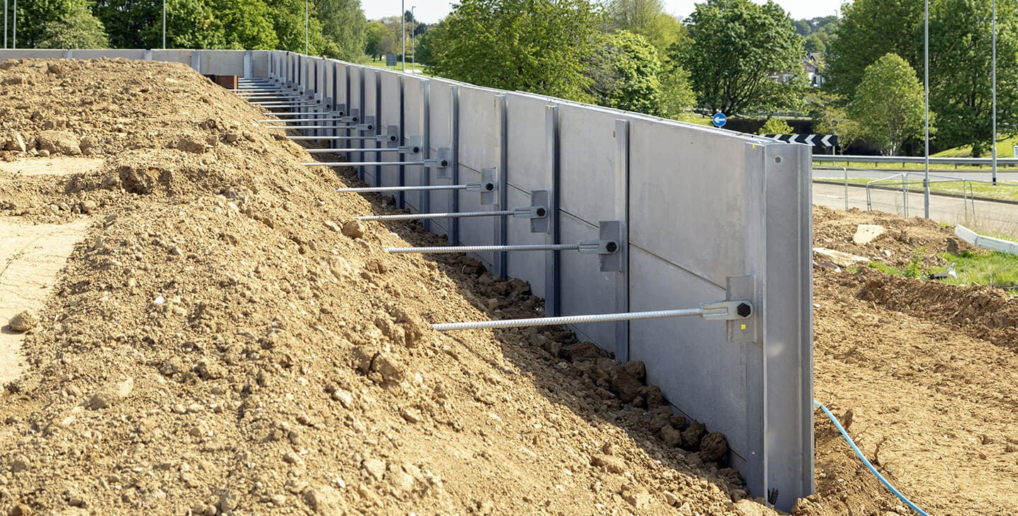 Precast concrete retaining wall with anchor rods