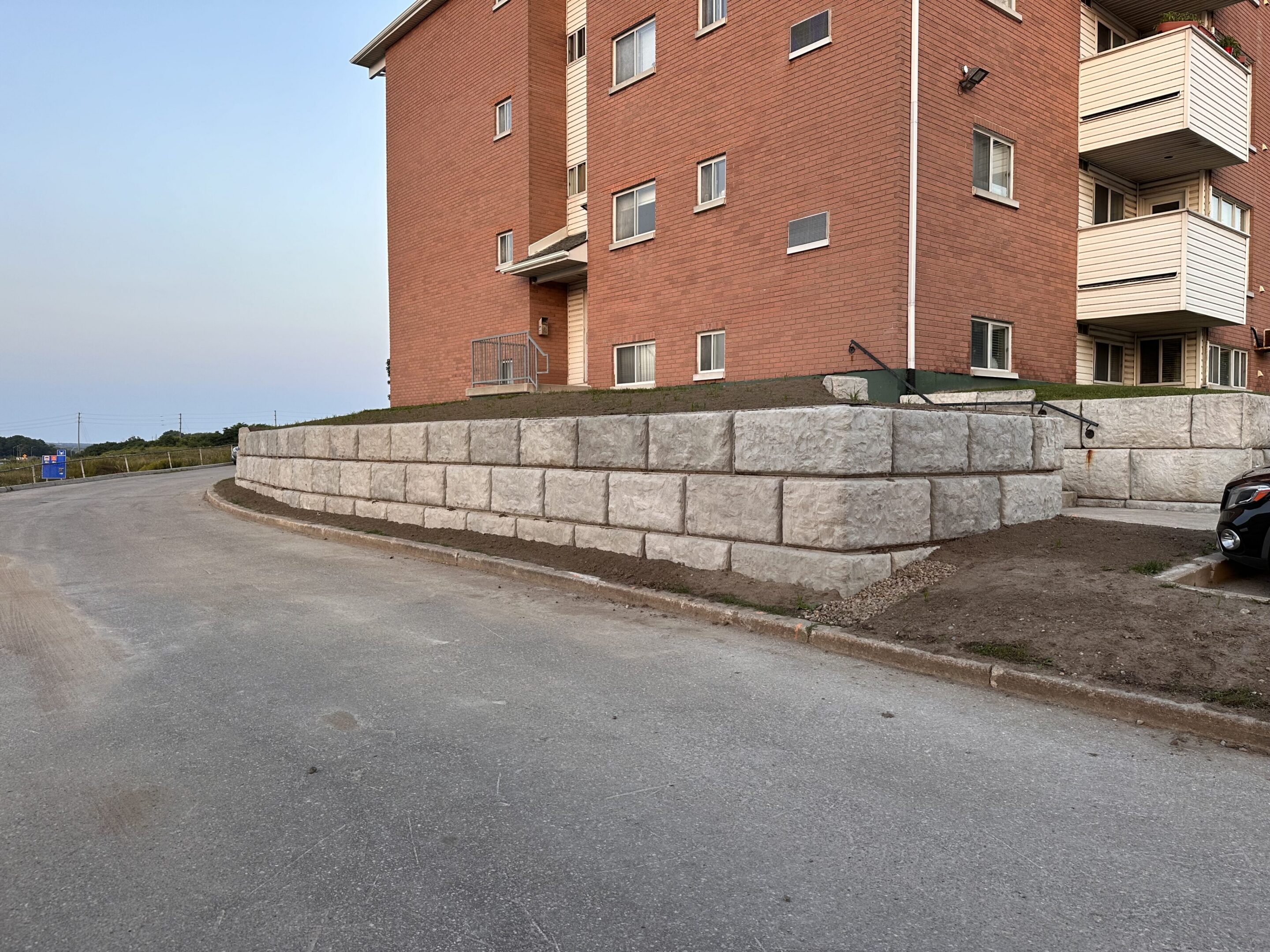 Brick apartment building with stone retaining wall