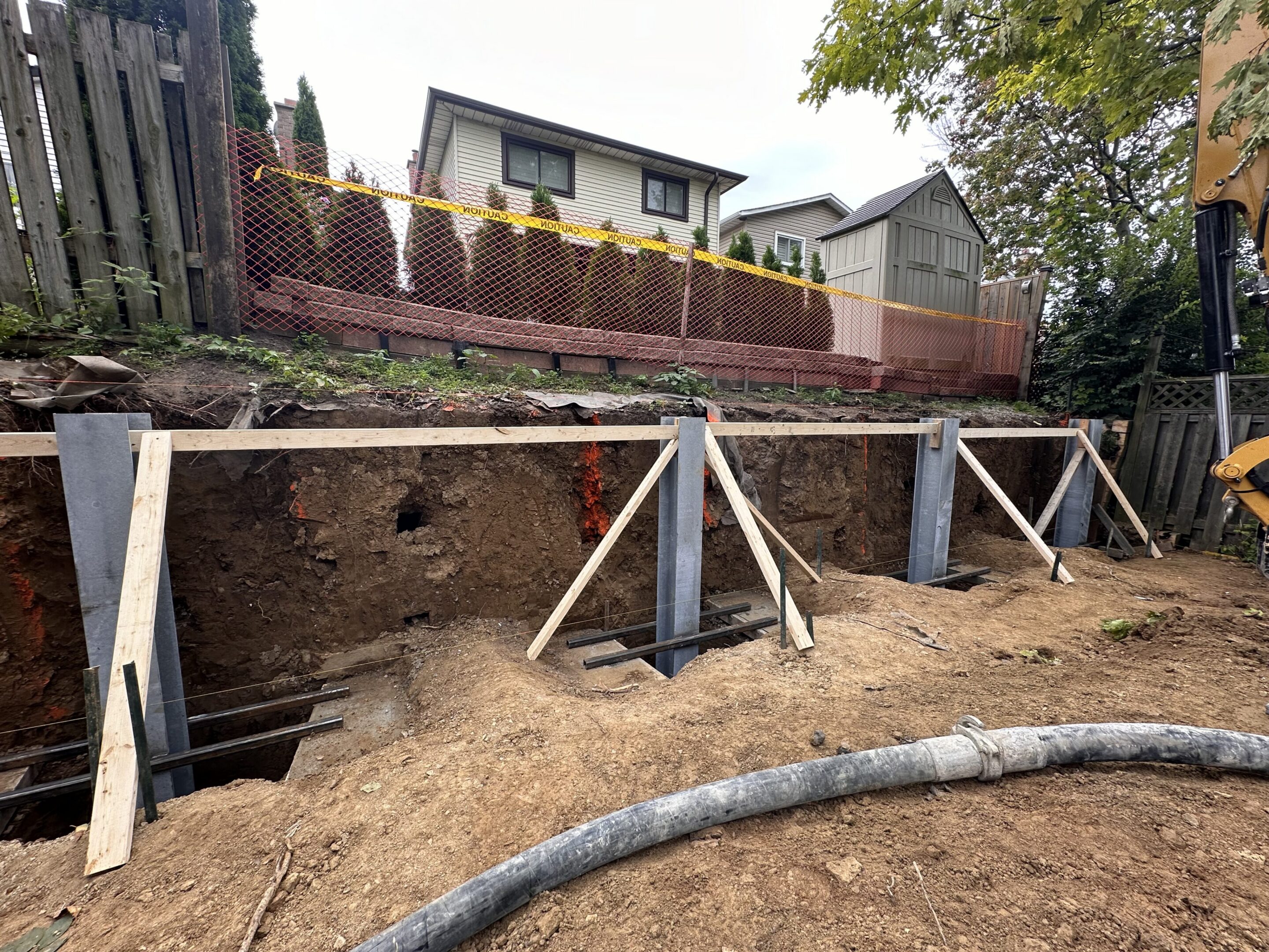 Backyard retaining wall construction with steel supports