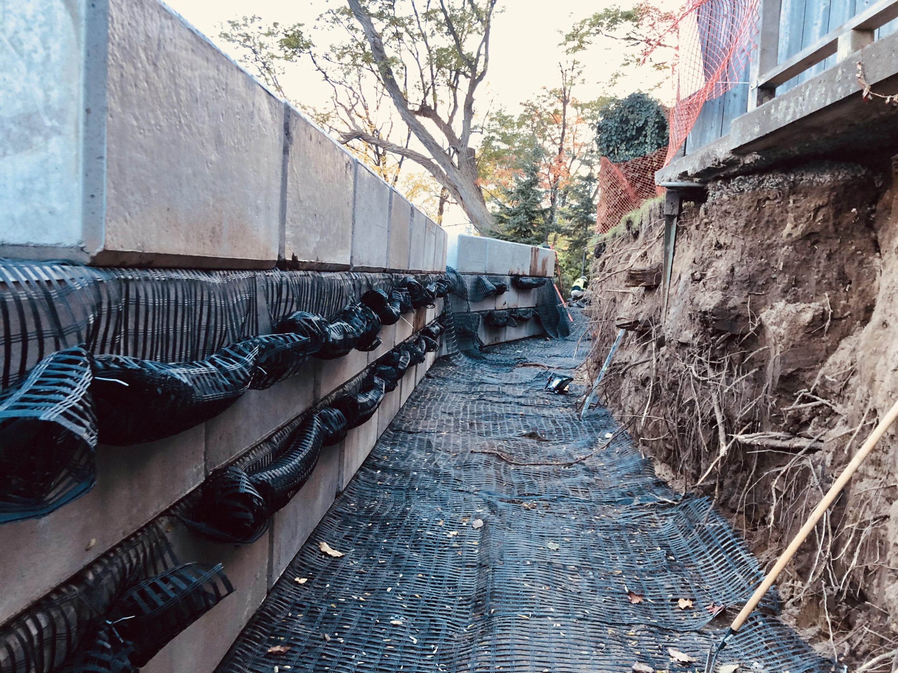 Retaining wall construction with drainage pipes