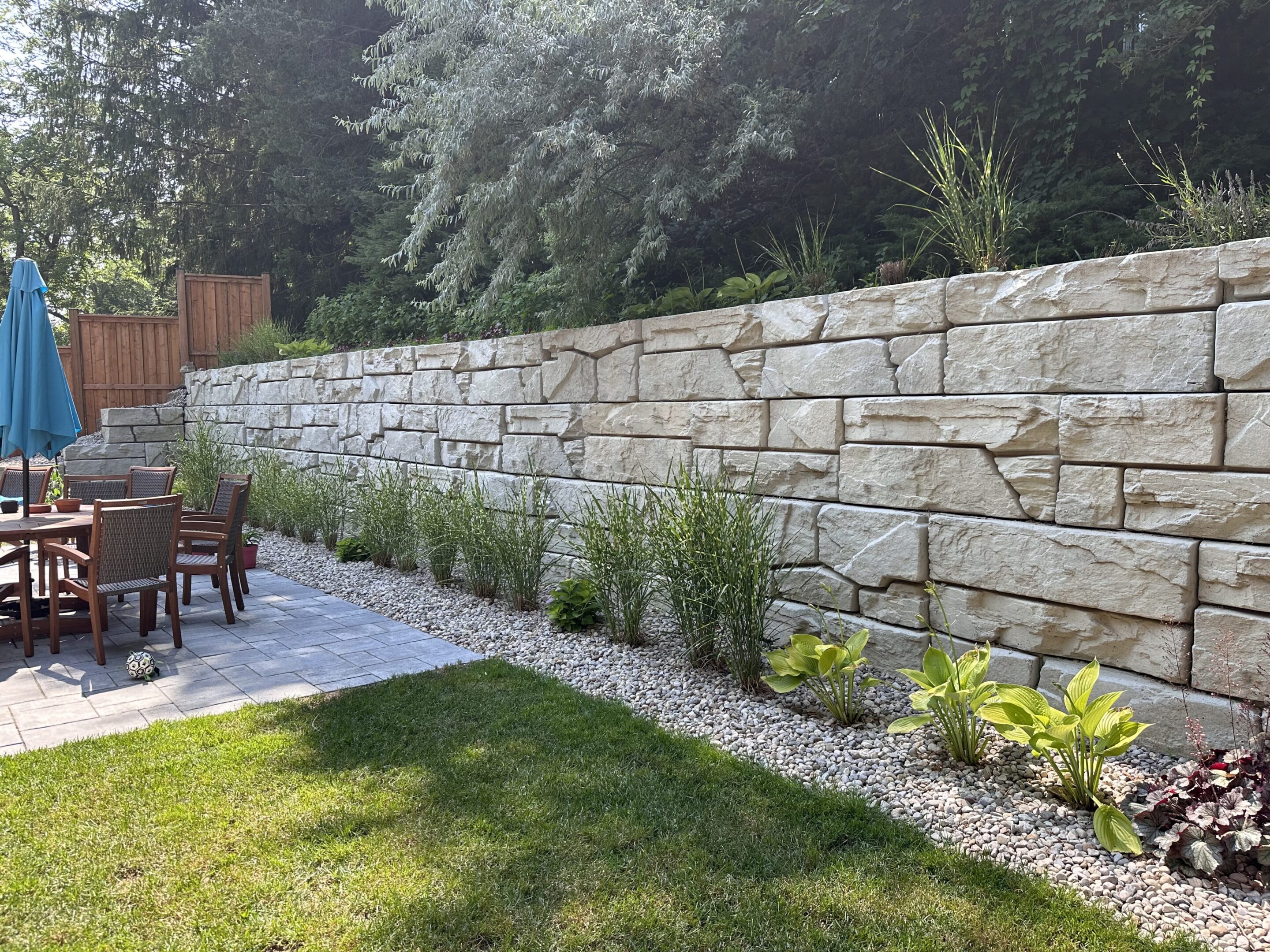 Backyard patio with stone retaining wall