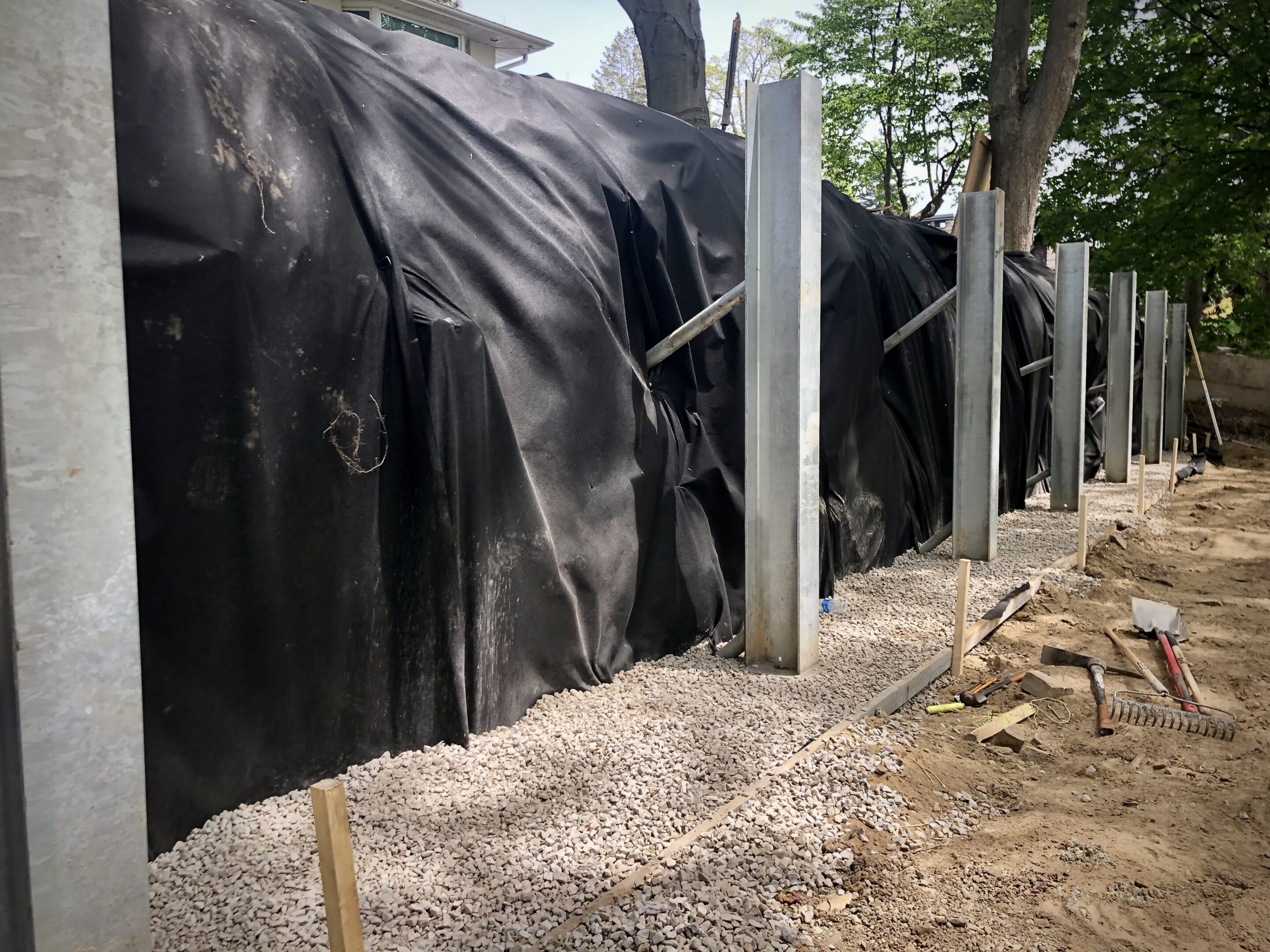 Construction site with metal posts and tarp